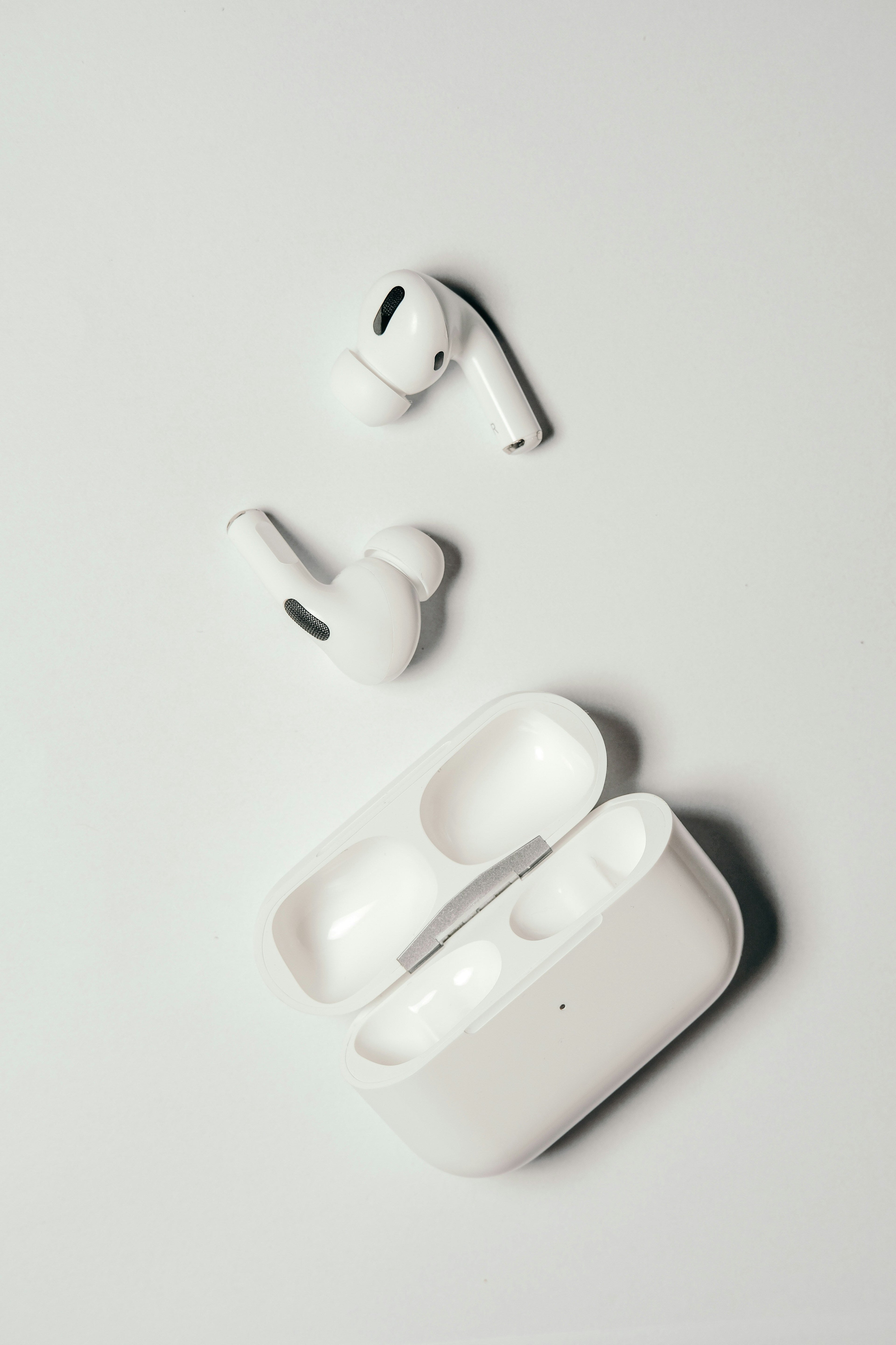 AirPods Pro and charging case on a plain background