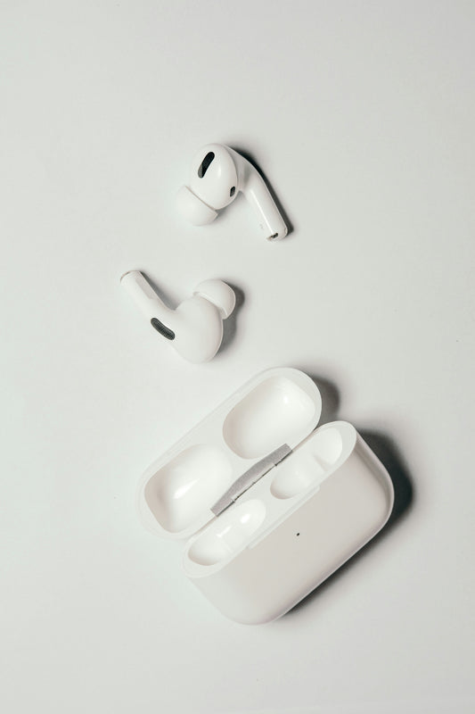AirPods Pro and charging case on a plain background